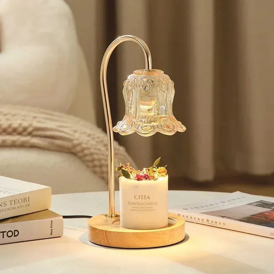 Elegant glass lampshade table lamp with candle, cozy modern home decor on a white table.