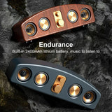 Dual wireless Bluetooth speakers with gold knobs and 2400mAh battery on rocky background
