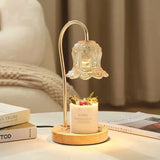 Elegant glass lampshade table lamp with candle, cozy modern home decor on a white table.