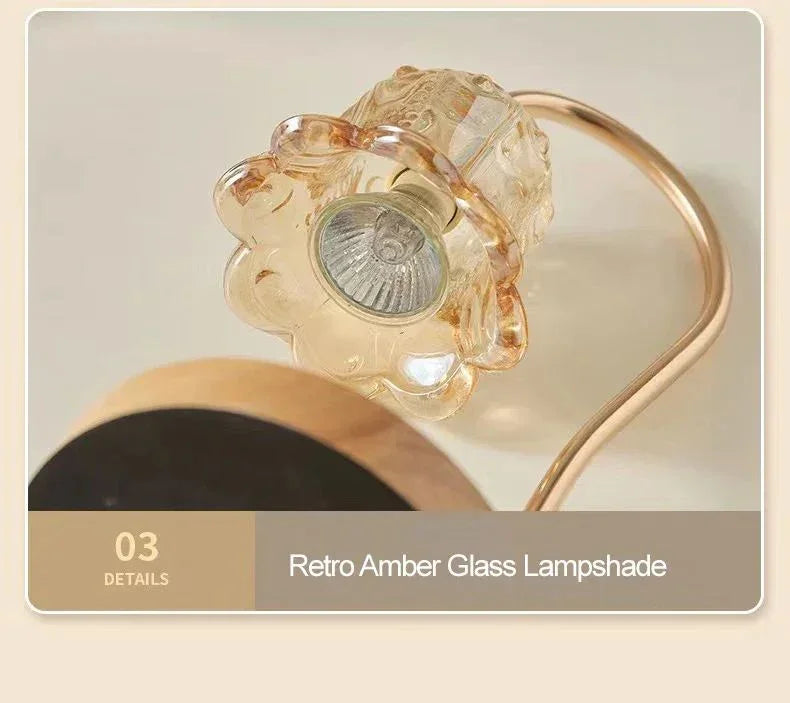 Close-up of retro amber glass lampshade with gold curved arm, modern home decor accent